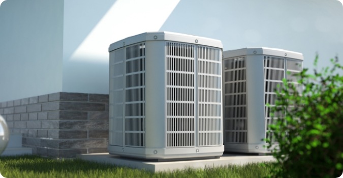 Two heat pumps outside of a house